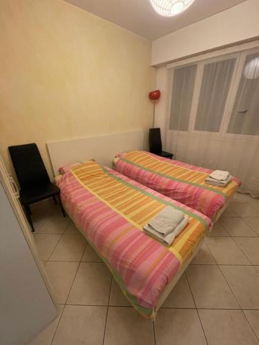 Ένα ή περισσότερα κρεβάτια σε δωμάτιο στο Appartement vue mer très proche de la plage et des commerces