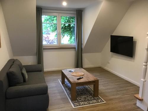 a living room with a couch and a coffee table at Naturblick in Hennstedt