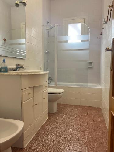 a bathroom with a toilet and a sink and a shower at Villa Barby in Lliria