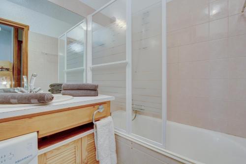 a bathroom with a sink and a shower at Sunny central studio in Morzine