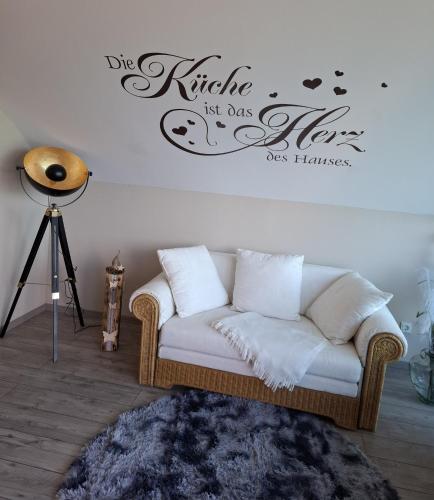 a living room with a couch and a wall at Ferienwohnung Mühlenhof in Duderstadt