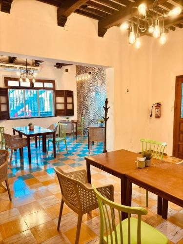 a dining room with tables and chairs in a room at Nicte Ha Campeche in Campeche
