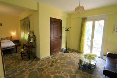 a living room with a couch and a table at Evaland Traditional Houses in Tarti