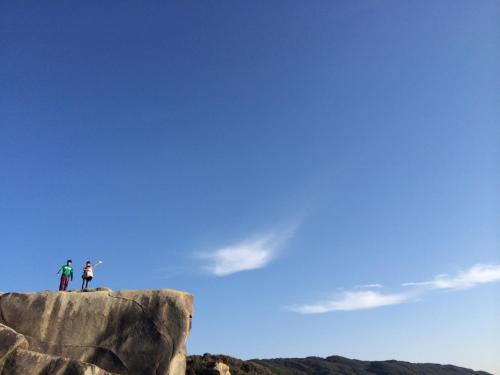 two people standing on top of a rock at Tanegashima Minshuku Yuyu in Minamitane