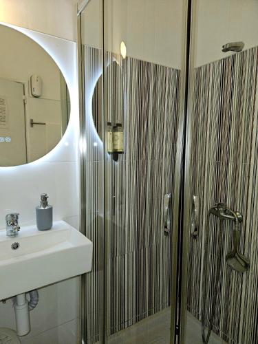 a bathroom with a sink and a shower at Alcamim Guesthouse in Elvas
