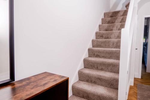 a stairway in a home with a stair case at Exquisite 3BD Nordic Retreat with Parking in Timperley