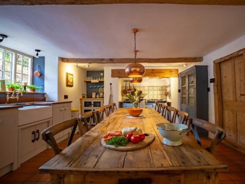 a wooden table in a kitchen with a plate of vegetables at 5 Bed in Dunster 63301 in Dunster