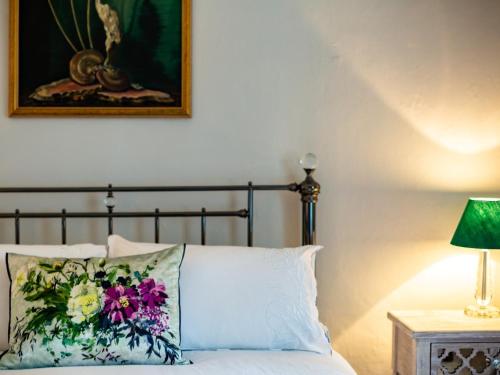 a bed with a pillow and a picture on the wall at 5 Bed in Dunster 63301 in Dunster