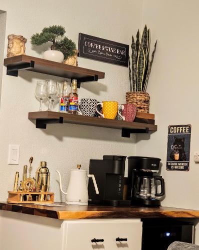 a kitchen counter with wooden shelves on the wall at Comfort Location Reasonable Price 2 blocks 2 the beach in Kailua-Kona