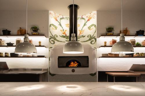 a fireplace in a kitchen with two chandeliers at Live Casino & Hotel - Louisiana in Bossier City