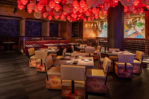 a restaurant with tables and chairs and red lights at Live Casino & Hotel - Louisiana in Bossier City