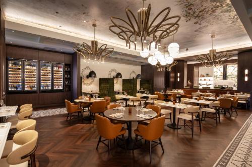 a restaurant with tables and chairs and chandeliers at Live Casino & Hotel - Louisiana in Bossier City