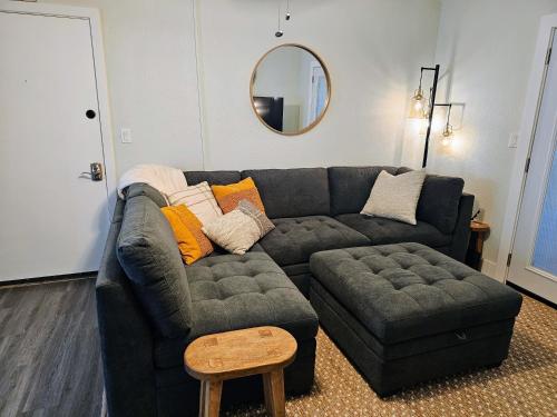 a living room with a couch and a ottoman at Comfort Location Reasonable Price 2 blocks 2 the beach in Kailua-Kona