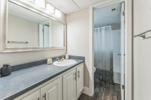 a bathroom with a sink and a mirror at Stratton 2501f I Comfy 2 Bed 2 Bath in Arlington