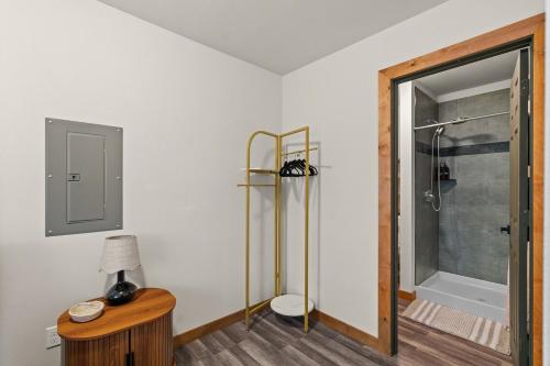 a bathroom with a shower and a table with a lamp at Rainier XL Chalet EV-Hot Tub-Game Room-Guest Suite in Ashford