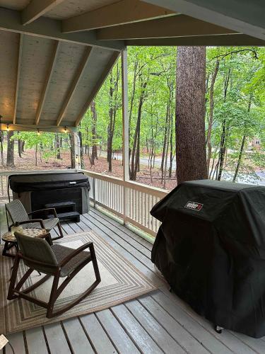 a screened in porch with a chair and a grill at Fireplace, Fire Pit & Resort Amenities in Hedgesville