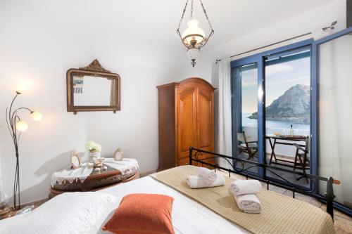 a bedroom with two beds and a view of the ocean at Villa Elias in Archangelos