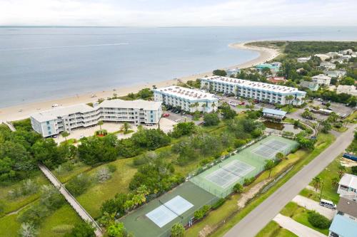 an aerial view of a resort with a tennis court and the beach at Beach Racquet A117 in Tybee Island