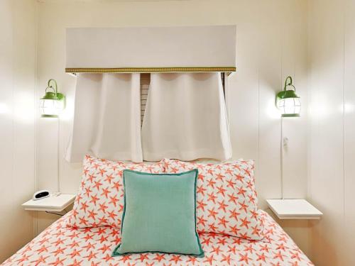 a bedroom with a bed with a headboard and pillows at Beach Racquet A117 in Tybee Island