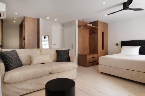 a living room with a couch and a bed at Kampana Corfu in luxury in Corfu