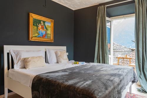 a bedroom with a large bed and a window at Villetta Panebianco Home in Castagna 11 by Rent All Como in Nesso