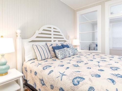 a bedroom with a bed with a blue and white comforter at Sea View 3 in Tybee Island