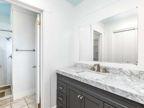 a bathroom with a sink and a mirror at Sea View 3 in Tybee Island