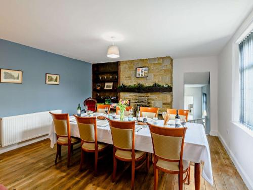 a dining room with a long table and chairs at 5 Bed in Bingley 91977 in Bingley
