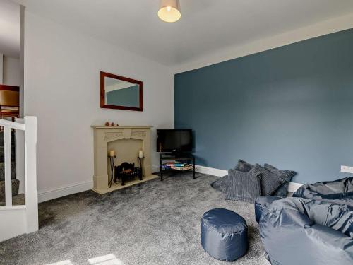 a living room with a couch and a tv at 5 Bed in Bingley 91977 in Bingley