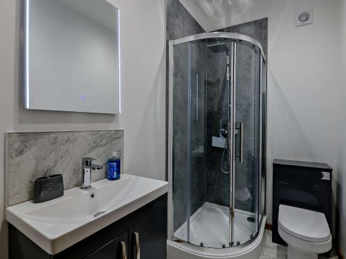 a bathroom with a shower and a sink and a toilet at 5 Bed in Bingley 91977 in Bingley