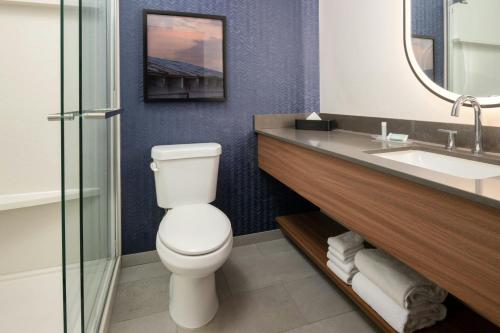 a bathroom with a toilet and a sink at Fairfield by Marriott Inn & Suites Scottsdale Old Town in Scottsdale