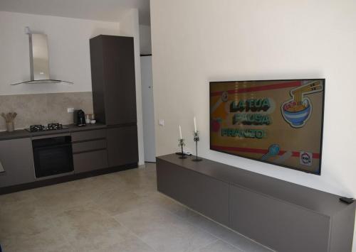 a kitchen with a flat screen tv on a wall at Casa con vista sul Duomo, 400 m da Piazza del Campo in Siena