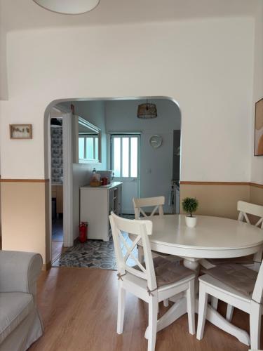 a dining room and living room with a table and chairs at City Break by StaySalmar in Torres Vedras
