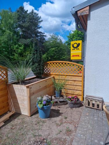 a garden with potted plants next to a building at Landidyll Monte Gristow in Mesekenhagen