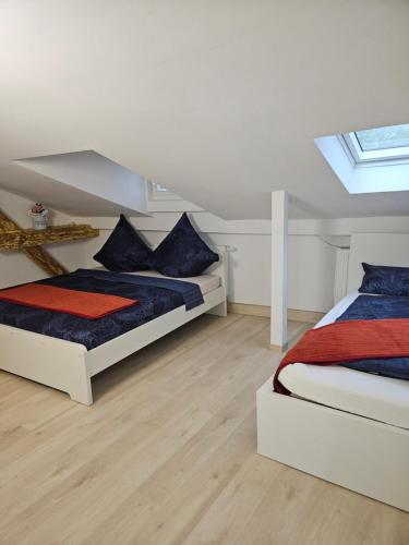 a bedroom with two beds and a skylight at Olymp 6-8 in Bamberg