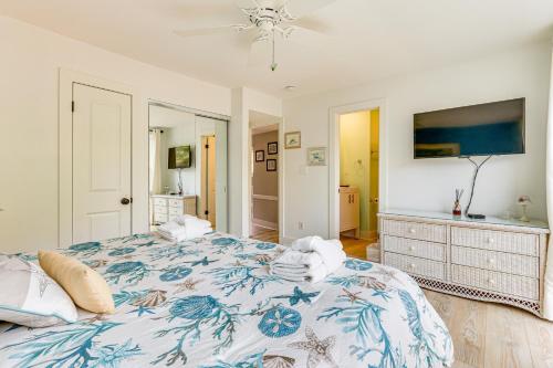 a bedroom with a large bed with a blue and white blanket at Walk to Beach Coligny Gem with Community Perks! in Hilton Head Island
