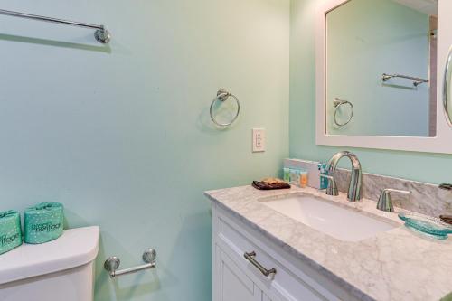 a bathroom with a sink and a mirror at Walk to Beach Coligny Gem with Community Perks! in Hilton Head Island