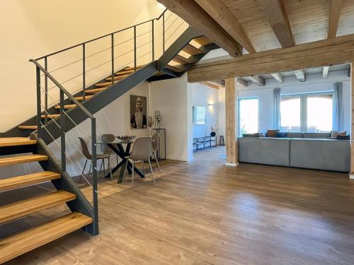 a living room with a staircase and a dining room at Landhaus Jarnitz in Ralswiek