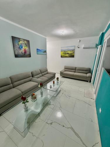 a living room with two couches and a glass table at Desire guest House in Pisa