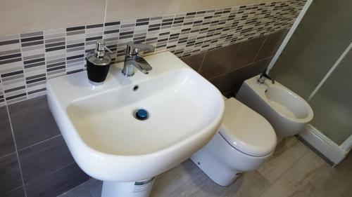 a bathroom with a white sink and a toilet at La Dimora Degli Artisti in Catanzaro