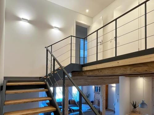 a staircase in a house with a glass railing at Landhaus Jarnitz in Ralswiek