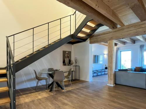 a dining room with a table and a staircase at Landhaus Jarnitz in Ralswiek
