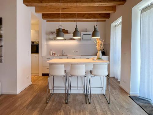 a kitchen with a island with bar stools at Landhaus Jarnitz in Ralswiek