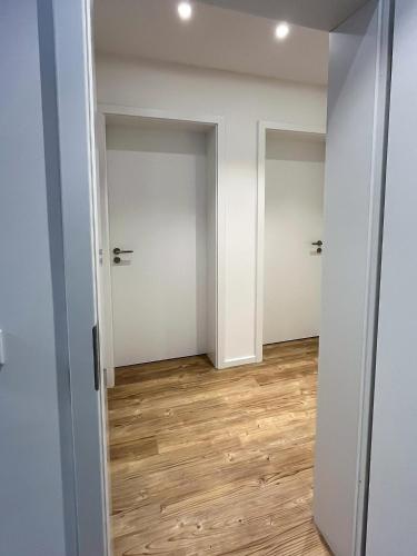 an empty room with white walls and wood floors at Landhaus Jarnitz in Ralswiek