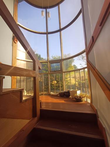 an attic room with a large glass window at The Red Brick Grove in Wonju