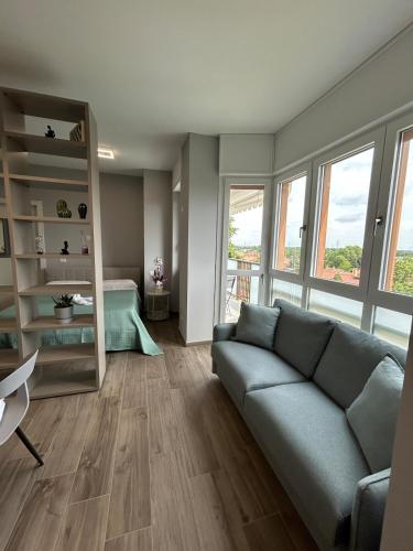 a living room with a couch and some windows at Modern House between Comfort, Style and Relax in Brugherio
