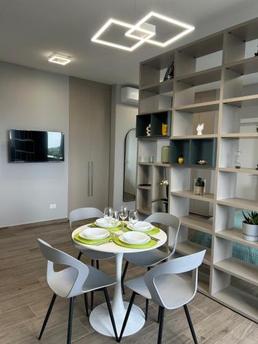 a dining room with a table and four chairs at Modern House between Comfort, Style and Relax in Brugherio