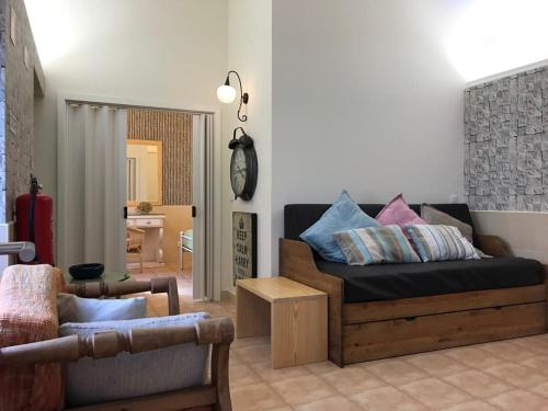 a living room with a couch and a chair at GuestReady - Volcanic Nature- Sea and Tranquillity in Mosteiros
