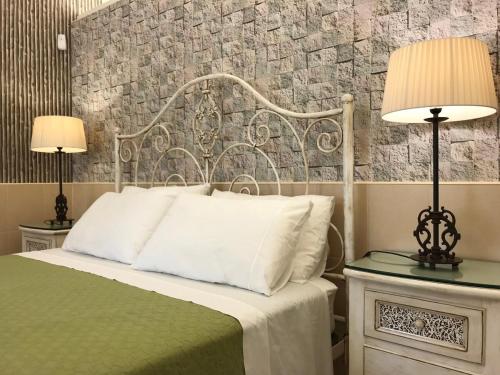 a bedroom with a bed and two lamps on tables at GuestReady - Volcanic Nature- Sea and Tranquillity in Mosteiros