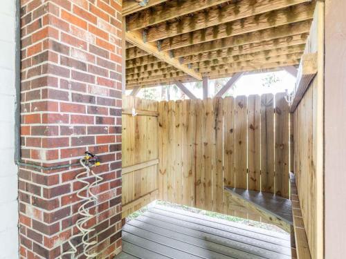 a wooden pergola with a wooden fence at Toes in the Sand in Tybee Island